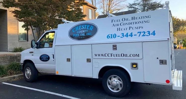 A Chester County Fuel Oil work van parked outside of a customer's home