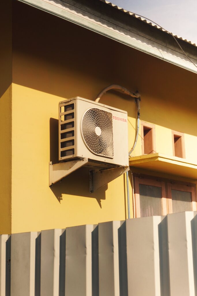 An air source heat pump outdoor unit mounted on a wall