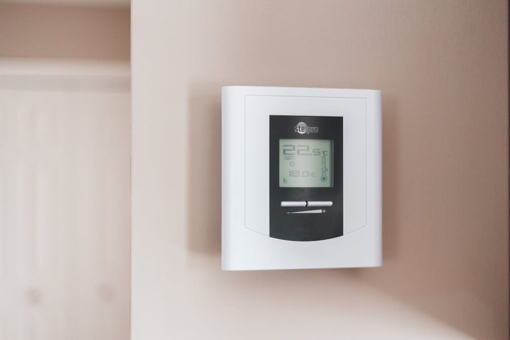 A smart thermostat mounted on a wall in a home.