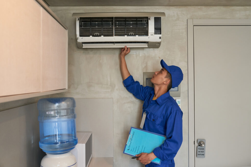 A technician fixing the air conditioning of a malvern  home